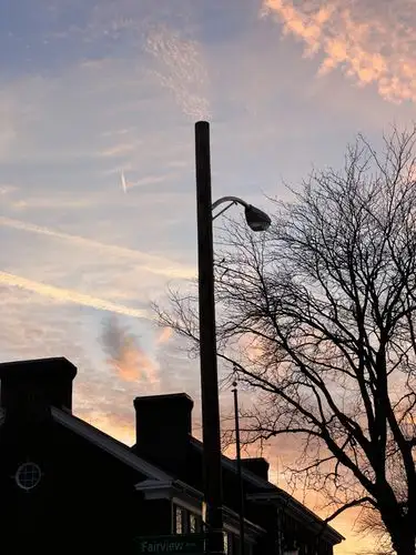 Painted skies over quiet streets at dusk.